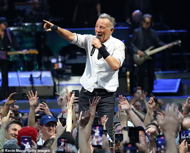 Bruce Springsteen walks past Chris Christie during concert encore, sparking viral debate.
